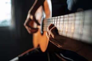 person playing guitar in a music therapy program