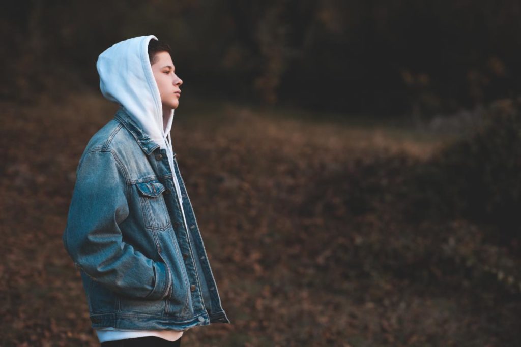 a depressed teen wanders aimlessly and alone deep in negative thought patterns