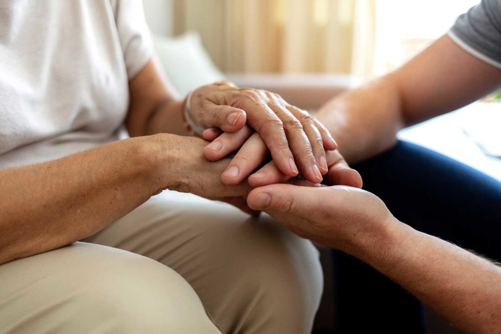 a teen is comforted by a counselor in trauma therapy after the loss of a parent