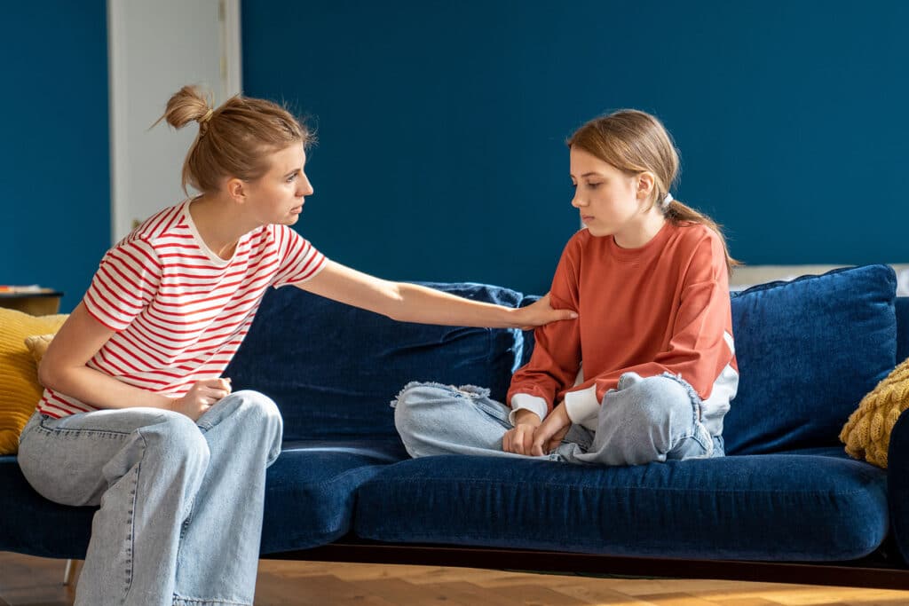 mother comforting daughter while explaining the benefits of crisis interventions